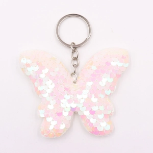 Detail of pink and white reversible sequins on butterfly keychain with metal ring