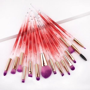 Macro detail of 15 makeup brushes with purple bristles and gradient diamond handles