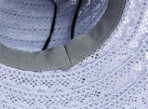 Detail of blue lace straw hat showing crochet texture, inner sweatband and adjustable cord