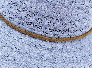 Close-up of lavender lace hollow sun hat featuring intricate crochet floral textures