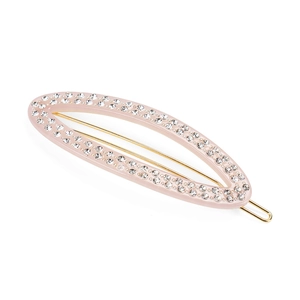 Close-up of pink acetate hair clip with rhinestones and gold metal fastener
