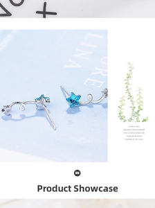 Macro view of blue pentagram crystal stud earrings with silver spiral metal accents