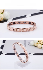 Detail of rose gold magnetic therapy bracelet featuring polished H-links and black magnets