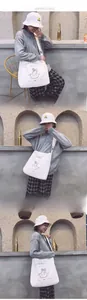 Detailed view of large white canvas crossbody bag with Aphrodite print and matching bucket hat