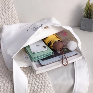 White large capacity canvas tote bag for women showing spacious interior with daily items