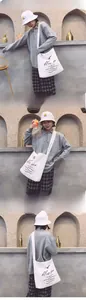 Lifestyle view of a white canvas shoulder bag with a summer print and a matching bucket hat