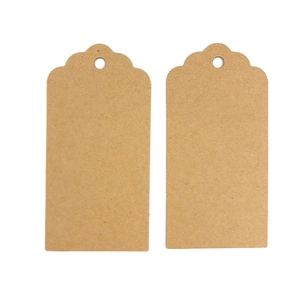 Pair of blank brown kraft paper gift tags with scalloped edges and pre-punched holes