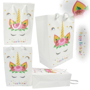 Detailed views of unicorn birthday paper gift bag with gold foil accents and rope handles