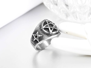 Macro shot of vintage star pattern on punk titanium steel ring for men in silver black