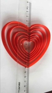 Five-piece set of red heart-shaped nested cookie cutters with precise size measurements