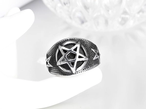 Macro shot of punk style hexagram ring with retro silver finish and hammered texture