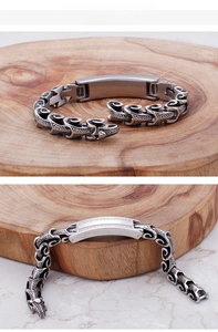Detailed macro view of vintage stainless steel dragon chain bracelet with zircon stones