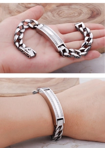 Detail of men's stainless steel curb chain bracelet with pavé zirconia ID plate