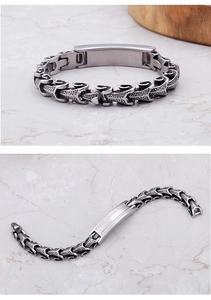 Macro detail of men's stainless steel dragon scale bracelet with smooth curved plate
