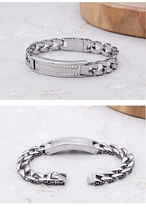 Macro detail of men's steel bracelet with zircon inlay and vintage floral relief
