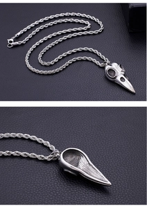 Macro view of gothic bird skull pendant with intricate vintage steel details and textured back
