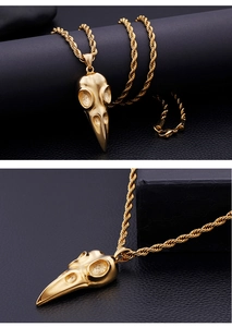 Detailed close-up of gothic golden bird skull pendant with premium twisted chain