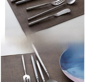 Detail of hand-polished stainless steel cutlery set with retro snowflake matte finish