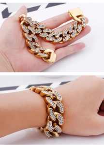 Macro detail of gold-plated iced out Cuban link bracelet with sparkling cubic zirconia