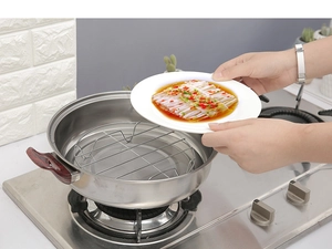Detail showing a stainless steel steaming rack being used in a pot for cooking vegetables