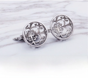 Macro shot of an intricate hollow spherical locket pendant with vintage floral patterns