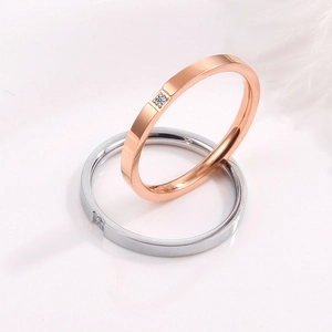 Minimalist rose gold and silver stainless steel rings with single diamond accents