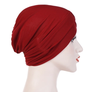 Red pleated elastic turban hat for women with cross-front design on model head
