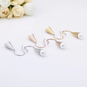 Elegant cone shell pearl earrings in silver, rose gold and gold finishes with floral decor