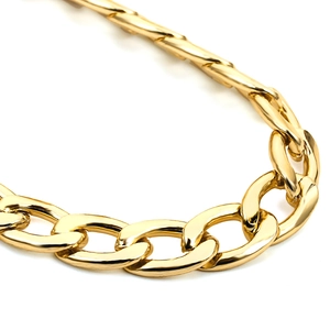 Macro shot of high-polished gold Cuban link body chain with reflective metallic finish