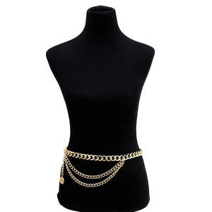 Vintage layered gold body chain with coin pendant displayed on a black mannequin