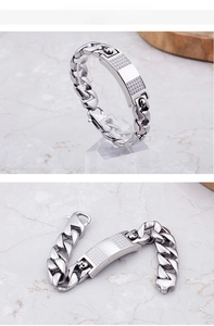 Detail of men's chunky cuban chain bracelet with iced-out skull plate and lobster clasp
