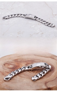 Macro detail of men's titanium steel Cuban link bracelet with skull and diamond inlay
