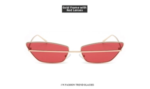 Close-up of gold metal frame and transparent red lenses on stylish cat-eye sunglasses