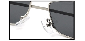 Macro shot of adjustable silicone nose pads and silver metal frame on cat eye sunglasses