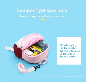 Spacious interior of kids pink cartoon backpack with toys, water bottle and stationery