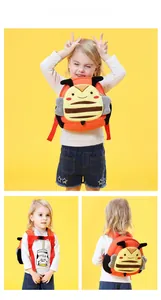 Detail of bee cartoon backpack with adjustable red shoulder straps and safety chest buckle