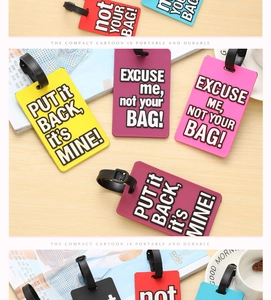 Detail of colorful PVC luggage tags with 'Not Your Bag' text and adjustable straps
