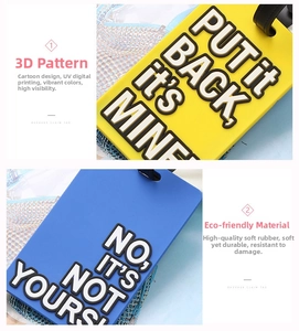 Detail of 3D PVC luggage tags with 'PUT IT BACK' and 'NOT YOURS' slogans in yellow and blue