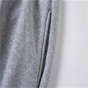 Detailed close-up of side pocket and knit texture on grey fleece jogger pants