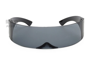 Detail view of the sleek wrap-around cyber lens and black frame on futuristic glasses