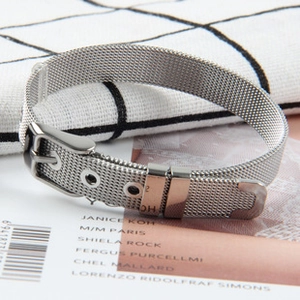 Close-up of silver mesh bracelet strap with metal buckle and adjustable texture