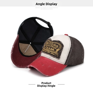Detailed macro view of distressed red brim with frayed holes on a vintage racing baseball cap