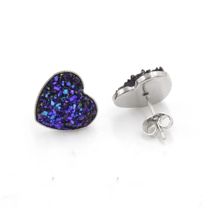 Detailed view of heart-shaped glitter studs with purple accents and butterfly backings