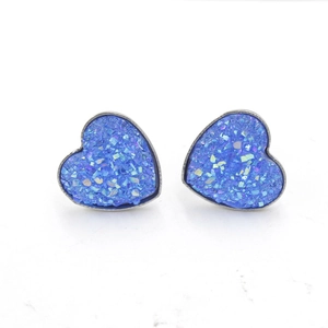 Sparkling blue heart stud earrings with silver frame and shimmering crystal texture