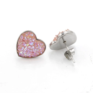 Macro shot of heart-shaped druzy stud earrings with pink crystal texture and metal backing