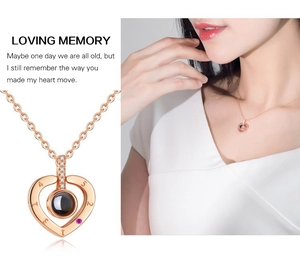 Detail of rose gold heart pendant with 521314 engraving and projection stone