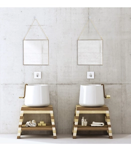 Detail of minimalist golden hexagonal mirrors with matching chains on industrial wall