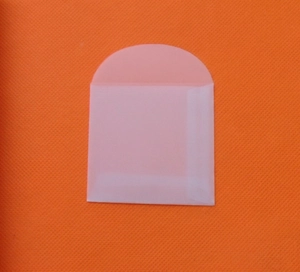 Detail of white translucent vellum paper envelope with a semicircular flap design