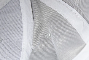 Macro detail of breathable mesh lining and reinforced stitching inside the suede baseball cap
