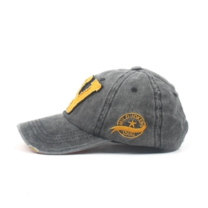 Vintage washed dark grey baseball cap with yellow V patch and distressed brim details